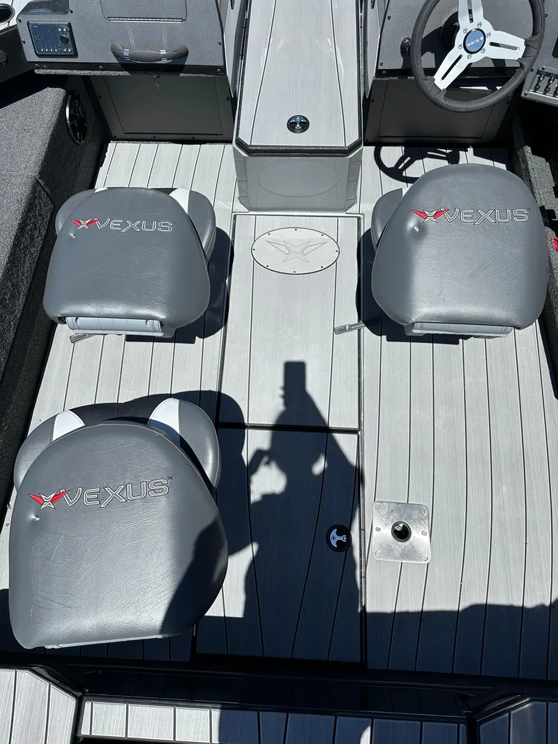 Slide: The Image of 2024 Vexus ADX180 boat interior with gray seats and steering console. - 18