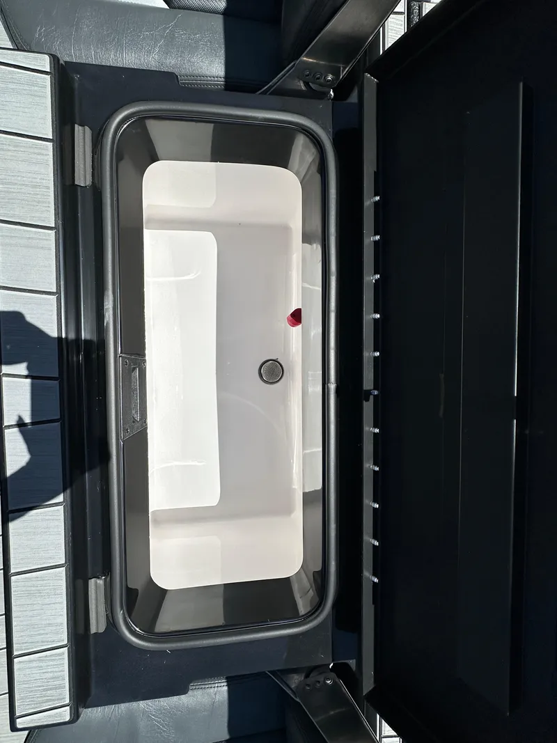 Slide: The Image of Vexus ADX180 2024 boat storage compartment with open lid. - 22