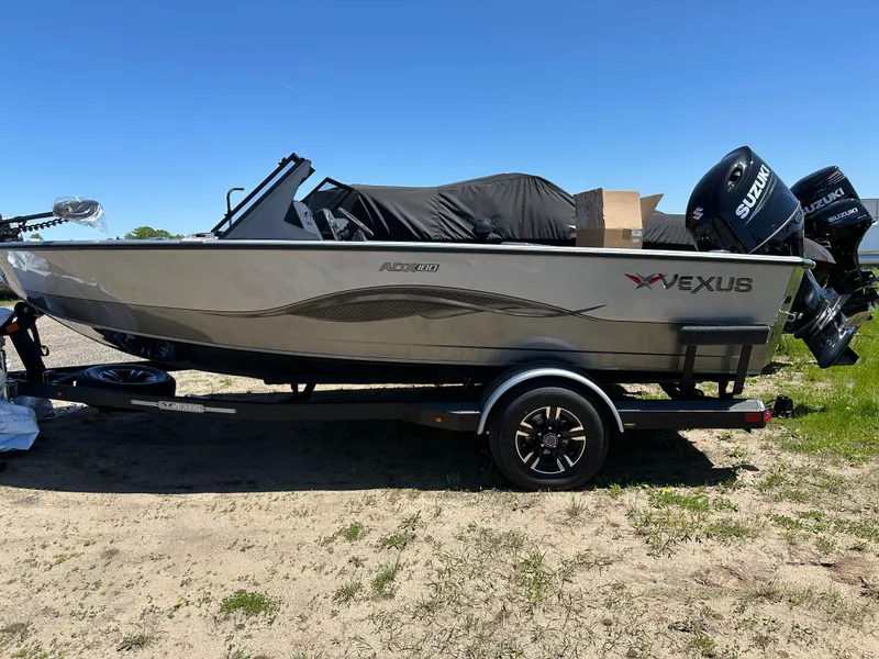 Slide: The Image of 2024 Vexus ADX180 boat on trailer with Suzuki outboard motor. - 31