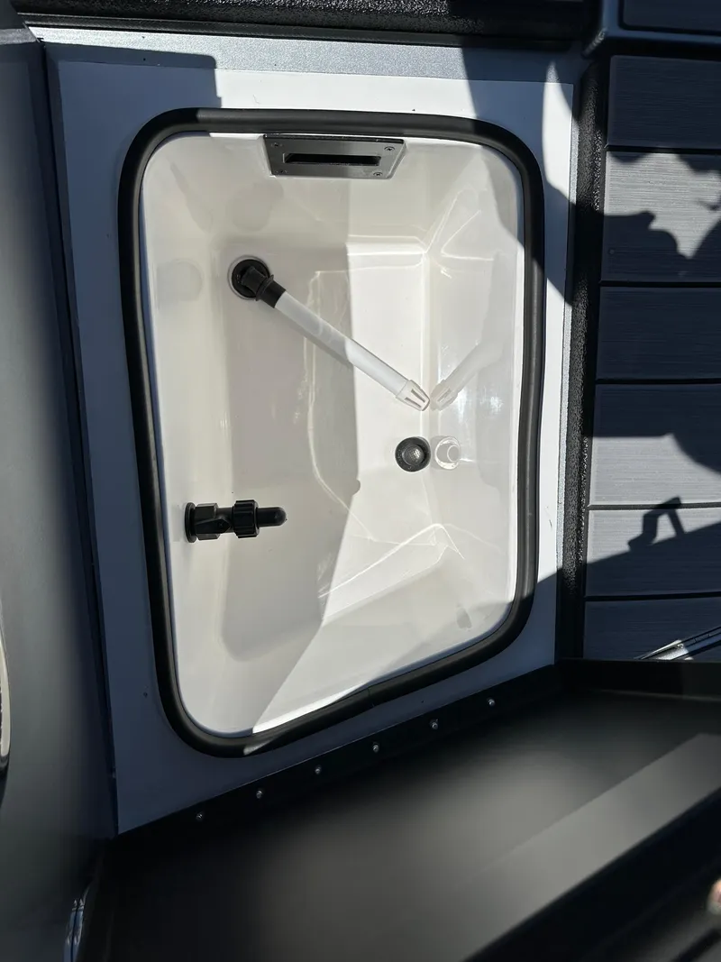Slide: The Image of 2024 Vexus ADX180 boat storage compartment with white interior. - 4