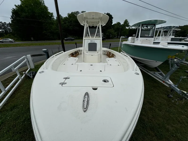 Slide: The Image of 2024 Pathfinder 2600 TRS boat on display, front view, white hull, outdoor setting. - 10