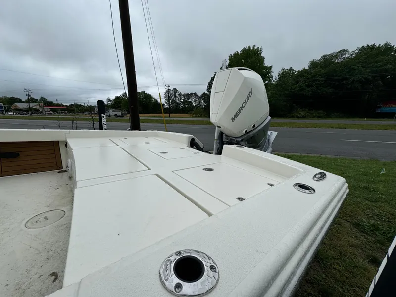 Slide: The Image of 2024 Pathfinder 2600 TRS boat with Mercury outboard motor, docked near a road. - 11