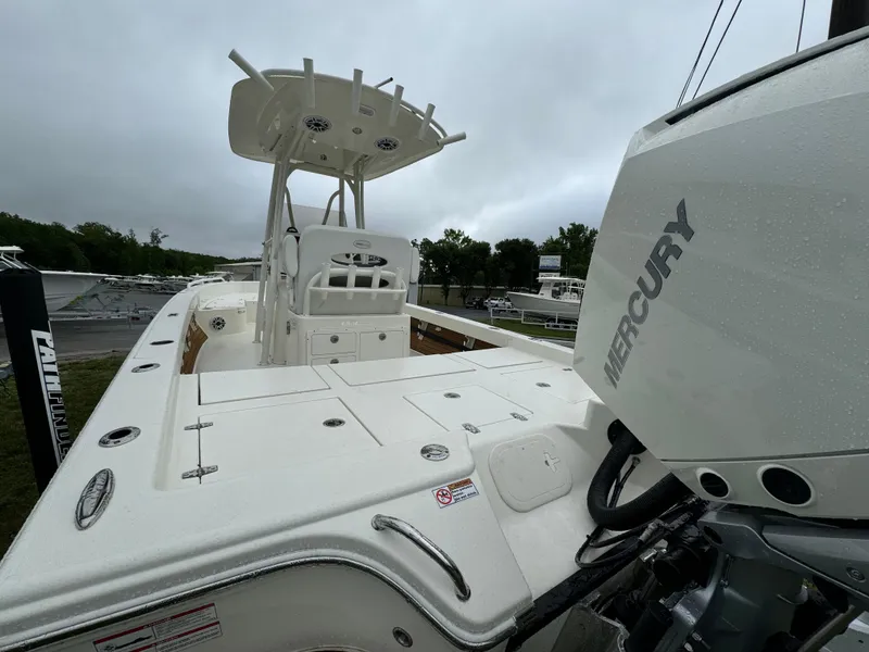 Slide: The Image of 2024 Pathfinder 2600 TRS boat with Mercury engine, wet deck, and center console. - 12