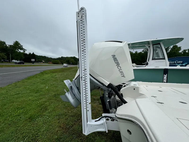 Slide: The Image of 2024 Pathfinder 2600 TRS boat with Mercury engine on grassy roadside. - 13