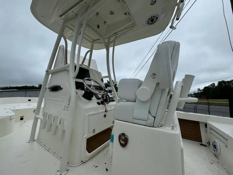 Slide: The Image of 2024 Pathfinder 2600 TRS boat interior with helm station and seating. - 4
