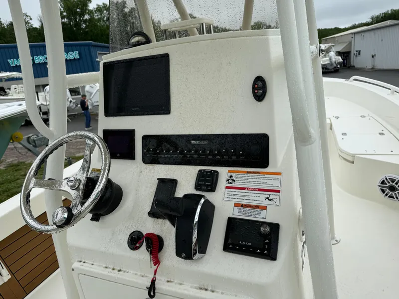 Slide: The Image of 2024 Pathfinder 2600 TRS boat console with steering wheel and electronic controls. - 7