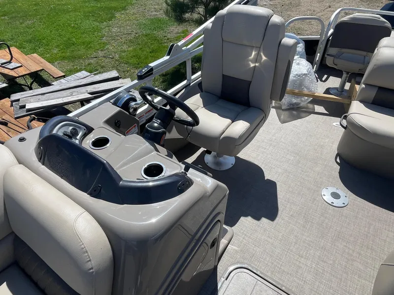 Slide: The Image of 2022 Sun Tracker SportFish 22 XP3 pontoon boat interior with captain's chair and console. - 10