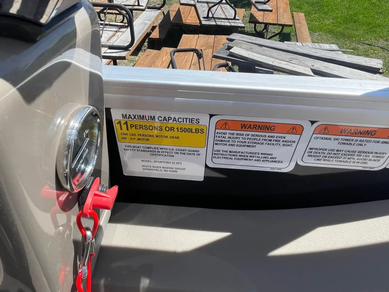 Slide: The Image of 2022 Sun Tracker SportFish 22 XP3 boat capacity and warning labels. - 11