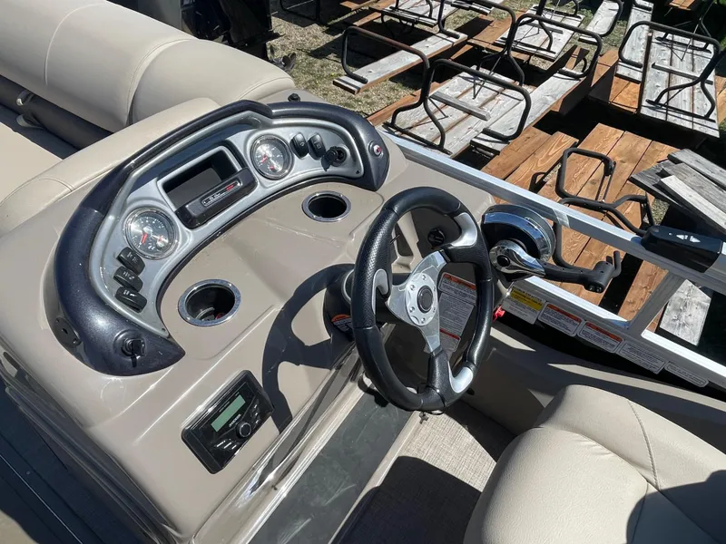 Slide: The Image of 2022 Sun Tracker SportFish 22 XP3 boat dashboard with steering wheel and control panel. - 12
