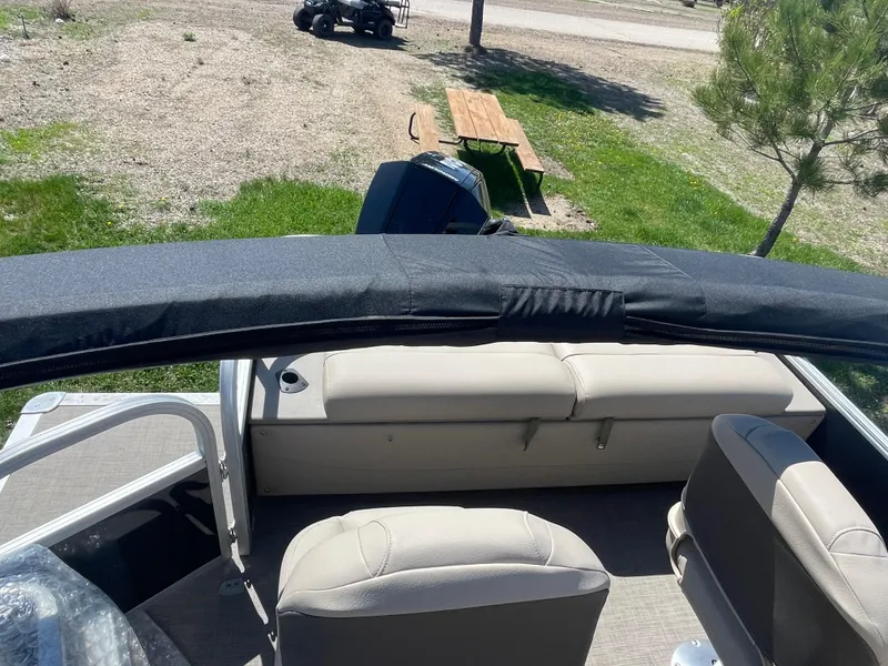 Slide: The Image of 2022 Sun Tracker SportFish 22 XP3 pontoon boat interior with seating and canopy. - 16