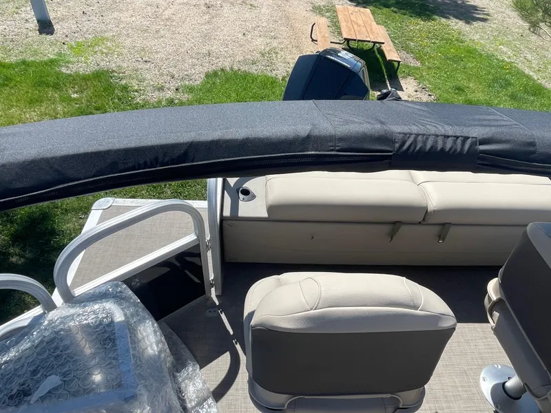 Slide: The Image of 2022 Sun Tracker SportFish 22 XP3 pontoon boat interior with seating and covered canopy. - 17