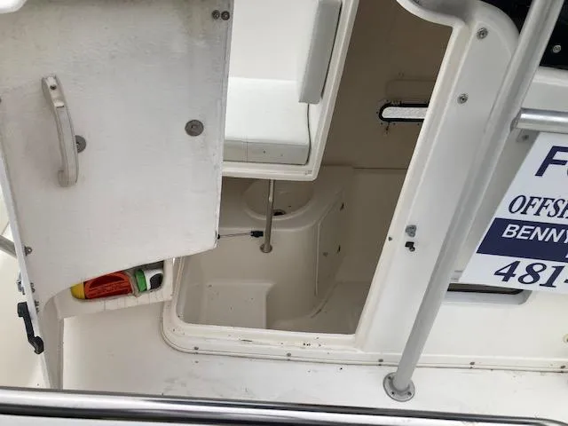 Slide: The Image of 1998 Century 2300 Center Console boat storage compartment with open door. - 10