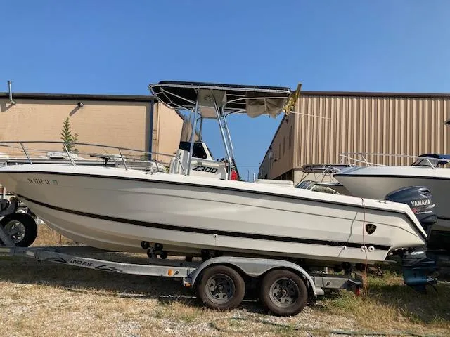Slide: The Image of 1998 Century 2300 Center Console boat on a trailer with Yamaha outboard motor. - 12