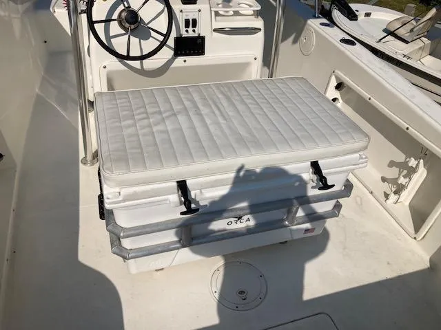 Slide: The Image of 1998 Century 2300 Center Console boat interior with cushioned seating and steering wheel. - 17