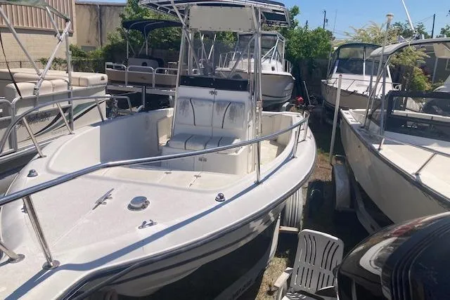 Slide: The Image of 1998 Century 2300 Center Console boat in a marina, surrounded by other vessels. - 22