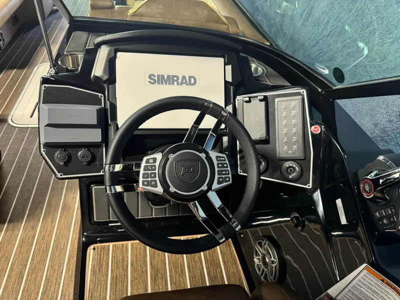 Slide: The Image of 2025 Premier 270 Super Sport RF boat dashboard with Simrad display and controls. - 13