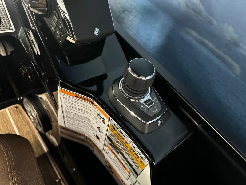 Slide: The Image of 2025 Premier 270 Super Sport RF boat control panel with joystick and warning labels. - 14