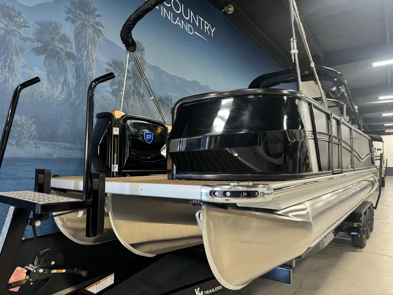 Slide: The Image of 2025 Premier 270 Super Sport RF pontoon boat in showroom, sleek black design. - 6