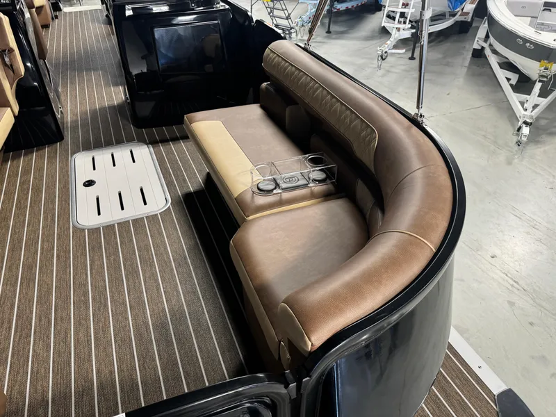 Slide: The Image of 2025 Premier 270 Super Sport RF boat interior with brown leather seating and striped flooring. - 9