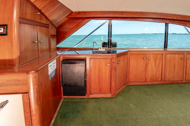 Slide: The Image of Interior of 1993 Jarrett Bay Convertible yacht with wooden cabinets and ocean view. - 32