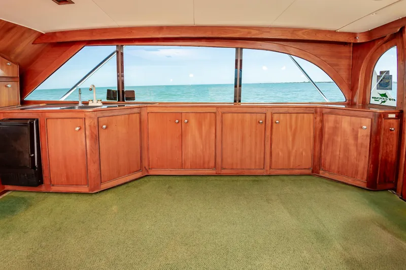 Slide: The Image of Interior of 1993 Jarrett Bay Convertible yacht with wooden cabinetry and ocean view. - 33