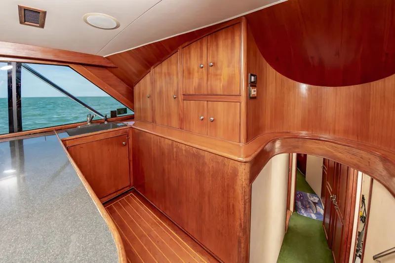 Slide: The Image of Interior of 1993 Jarrett Bay Convertible yacht with wooden cabinetry and ocean view. - 35