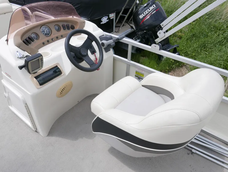 Slide: The Image of 2007 Sedona L23 boat cockpit with steering wheel, controls, and comfortable seating. - 6