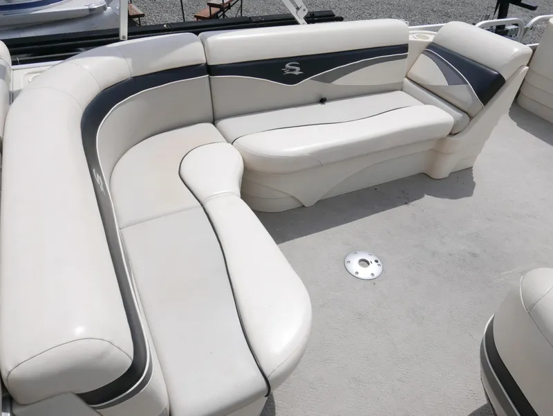 Slide: The Image of Luxurious seating on a 2007 Sedona L23 boat, featuring elegant white and gray upholstery. - 8