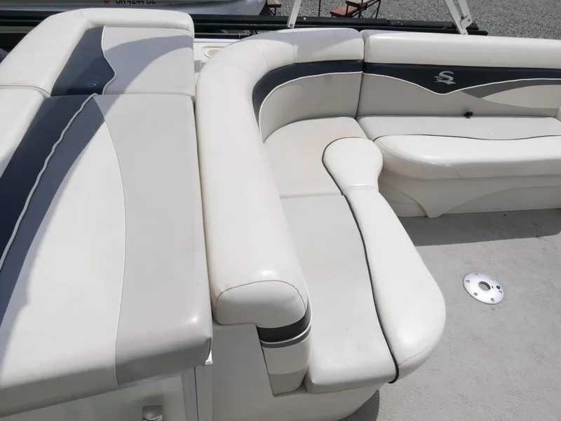 Slide: The Image of 2007 Sedona L23 boat interior with white and gray seating. - 9
