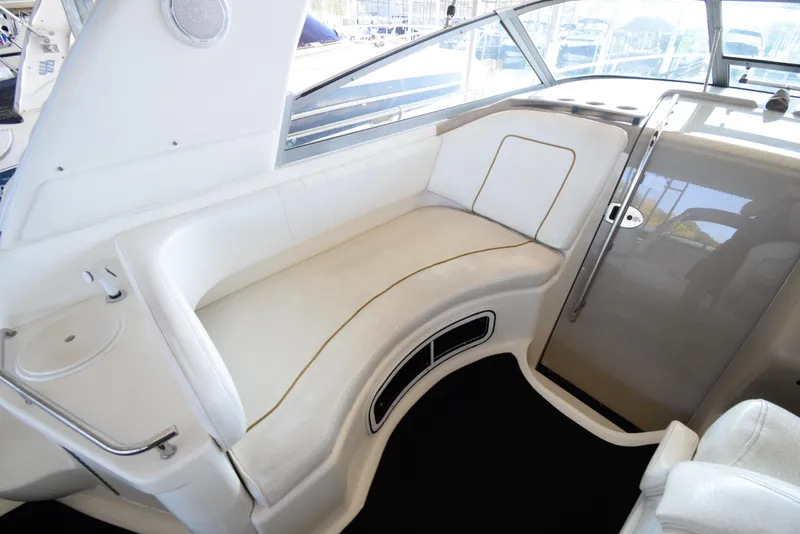 Slide: The Image of 1999 Sea Ray 290 Sundancer interior seating area with white upholstery. - 14