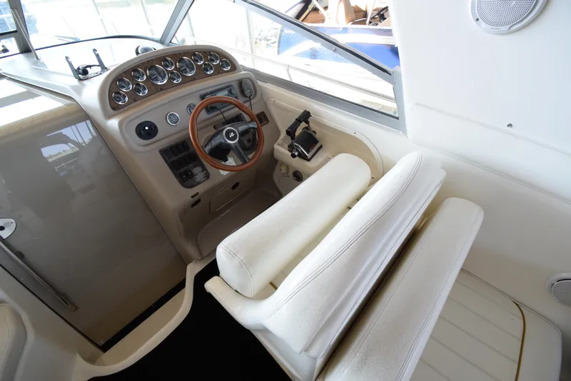 Slide: The Image of 1999 Sea Ray 290 Sundancer helm with steering wheel and control panel. - 16
