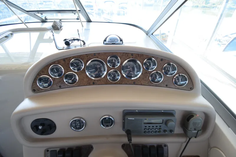 Slide: The Image of 1999 Sea Ray 290 Sundancer dashboard with gauges and controls. - 19