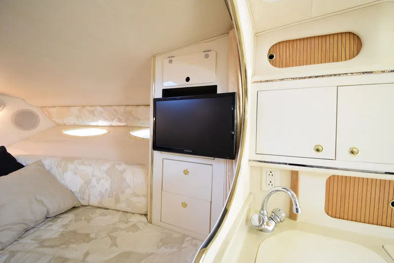 Slide: The Image of Interior cabin of 1999 Sea Ray 290 Sundancer with TV, bed, and sink. - 27