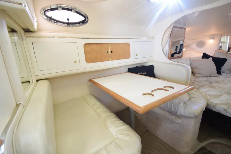 Slide: The Image of Interior of 1999 Sea Ray 290 Sundancer with dining area and sleeping quarters. - 30