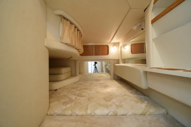 Slide: The Image of Interior cabin of a 1999 Sea Ray 290 Sundancer boat with beige upholstery. - 32