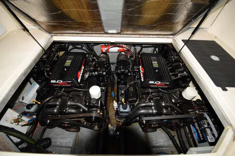 Slide: The Image of 1999 Sea Ray 290 Sundancer engine compartment with twin MerCruiser 5.0L engines. - 36