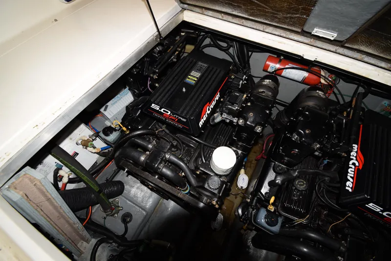 Slide: The Image of 1999 Sea Ray 290 Sundancer engine compartment with twin MerCruiser 5.0L engines. - 37