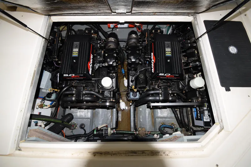 Slide: The Image of 1999 Sea Ray 290 Sundancer engine compartment with twin MerCruiser 5.0L engines. - 39