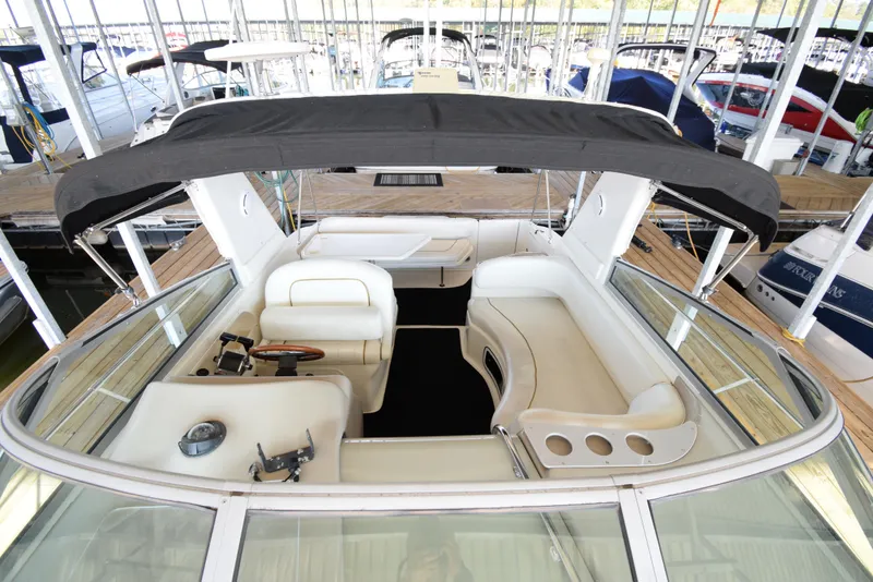 Slide: The Image of 1999 Sea Ray 290 Sundancer boat interior with seating and canopy. - 4