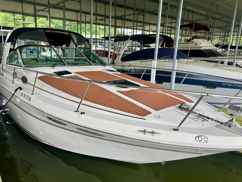 Slide: The Image of 1999 Sea Ray 290 Sundancer docked in a marina. - 40