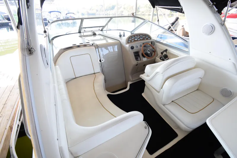 Slide: The Image of 1999 Sea Ray 290 Sundancer boat interior with helm and seating area. - 6