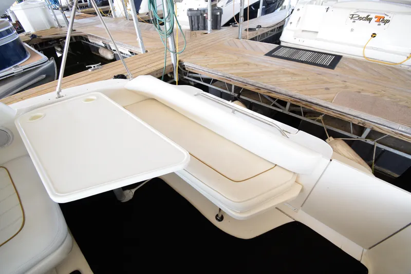 Slide: The Image of 1999 Sea Ray 290 Sundancer boat interior with seating and table. - 8