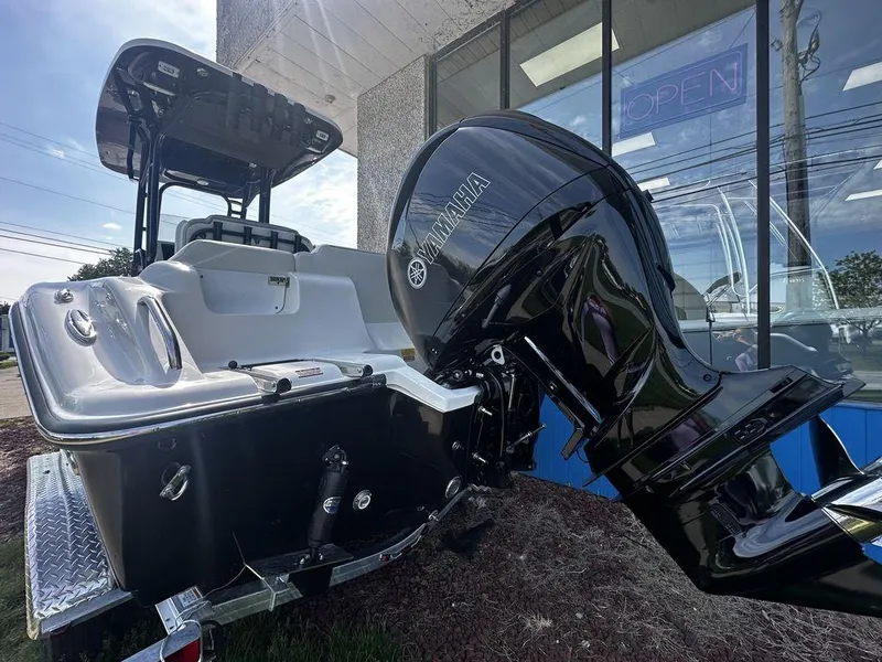 Slide: The Image of 2024 Key West 239 FS boat with Yamaha outboard motor displayed outside a showroom. - 2