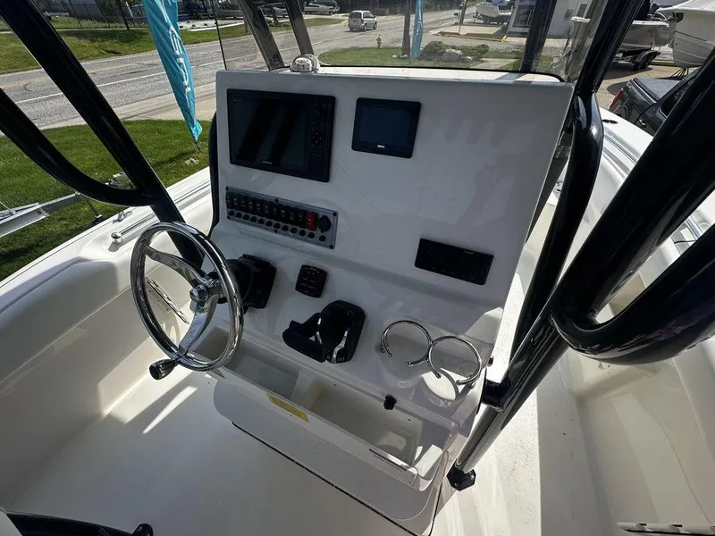 Slide: The Image of 2024 Key West 239 FS boat console with steering wheel and navigation controls. - 3