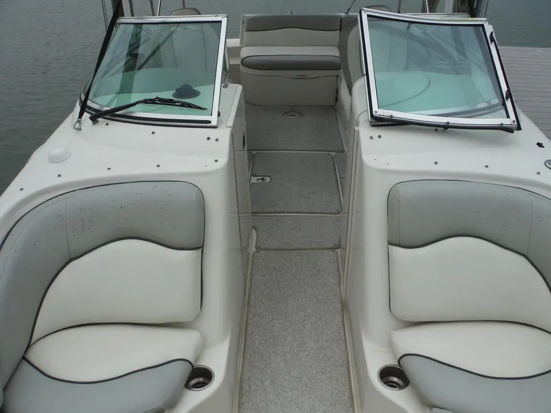Slide: The Image of 2007 Sea Ray 240 Sundeck interior with seating and open windshield. - 23