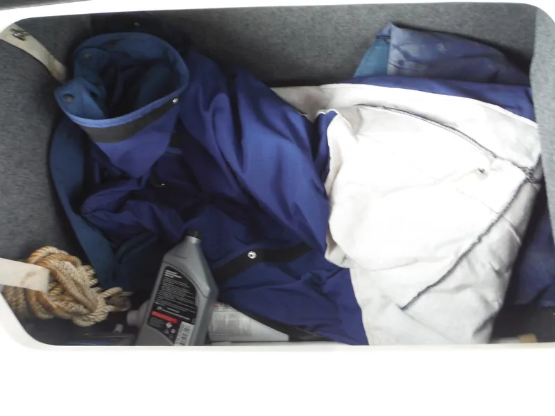 Slide: The Image of Storage compartment of a 2007 Sea Ray 240 Sundeck with ropes, oil, and fabric. - 29