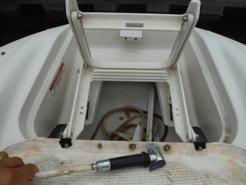 Slide: The Image of 2007 Sea Ray 240 Sundeck storage compartment with rope and anchor. - 22