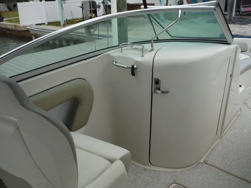 Slide: The Image of 2007 Sea Ray 240 Sundeck interior with seating and windshield. - 26