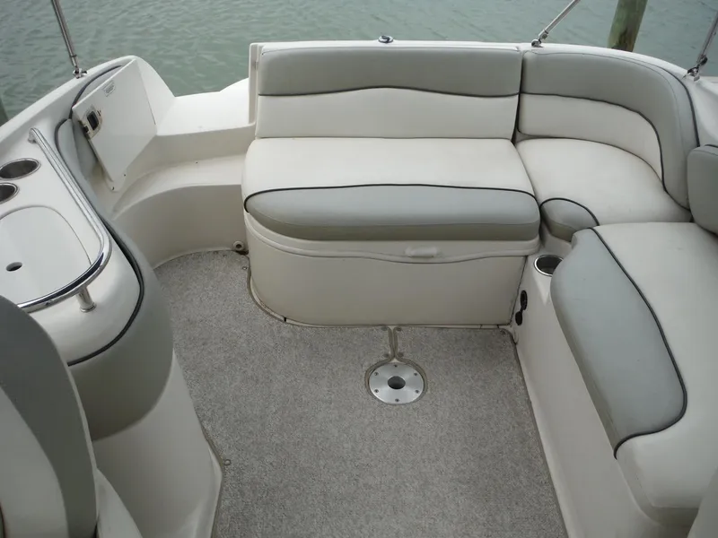 Slide: The Image of 2007 Sea Ray 240 Sundeck interior seating area with gray and white upholstery. - 11
