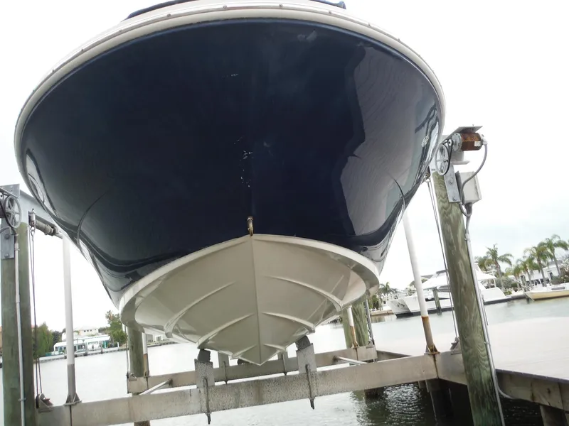 Slide: The Image of 2007 Sea Ray 240 Sundeck boat on a lift at a marina. - 34